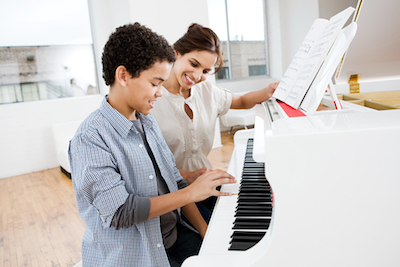 BoyPlayingPianoTeacher_400 GettyImages 96162171